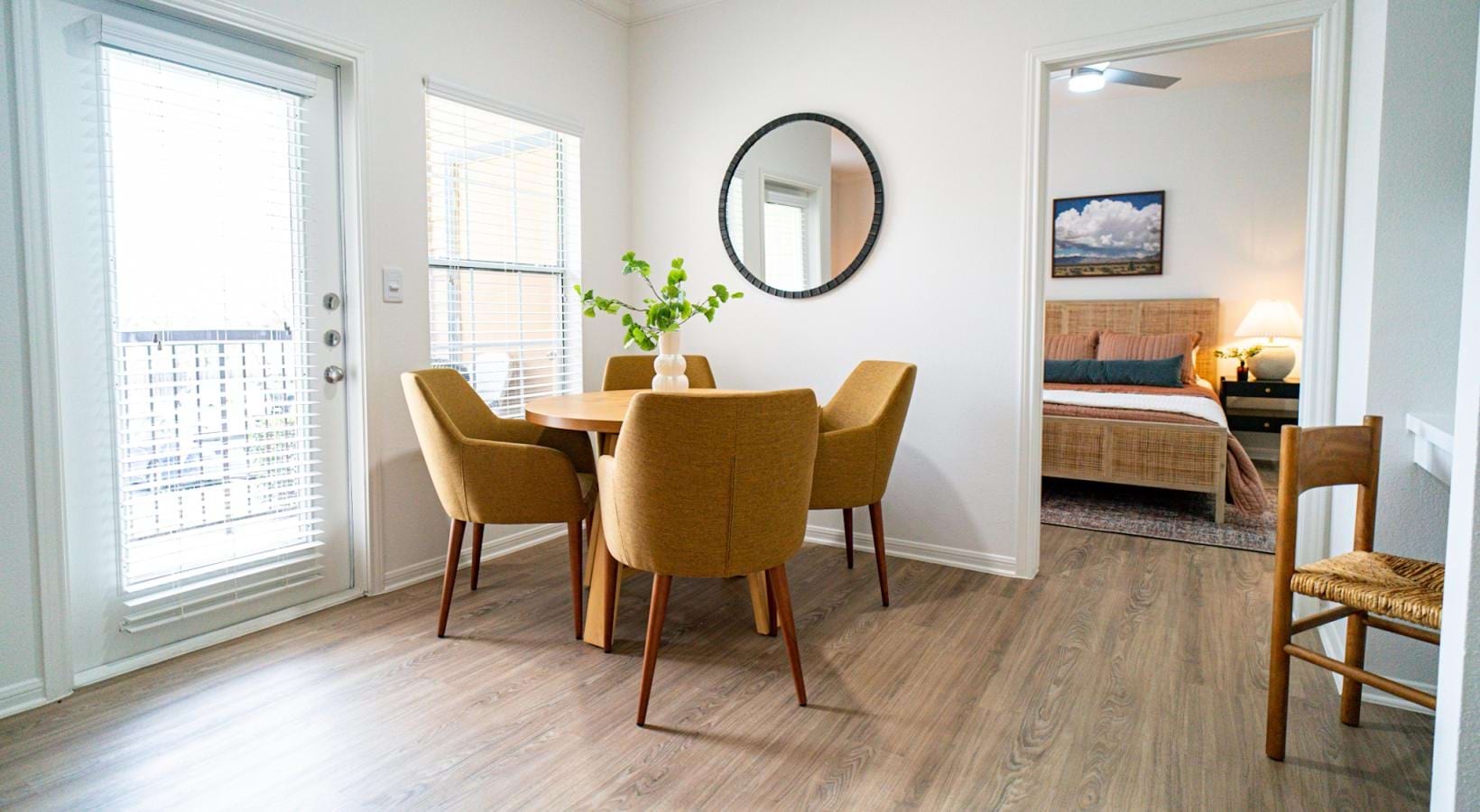 Generous living spaces with beautiful natural lighting dining table and chairs next to large window and access to private balcony