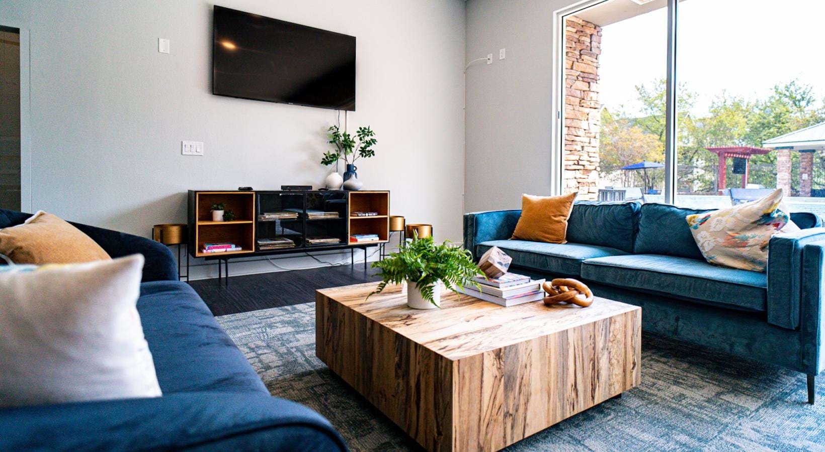 Settle into comfort at The Reserve at Walnut Creek wall mounted tv and couches in clubhouse