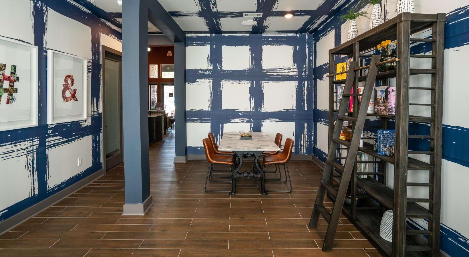 Access to resident-only features bookshelves and dining table in clubhouse